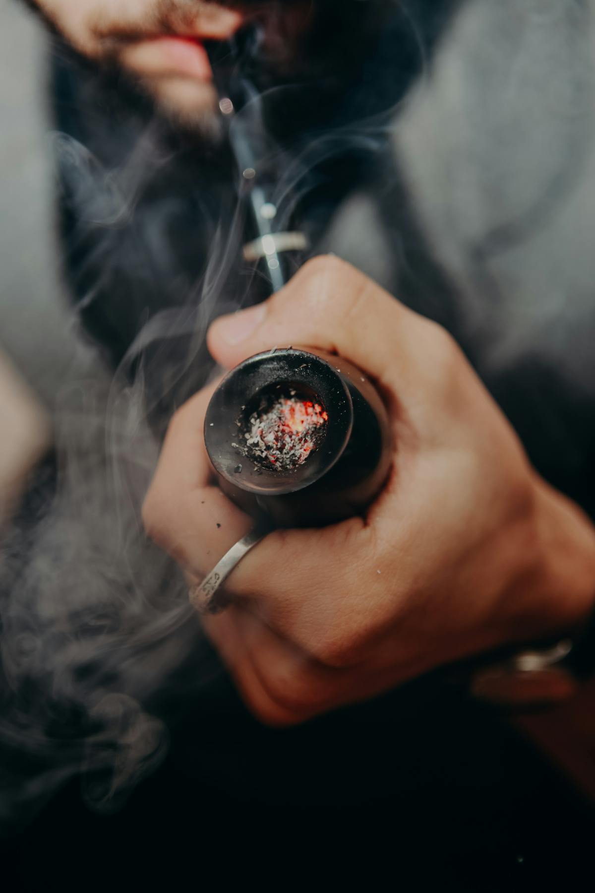 A hand holding a classic smoking pipe